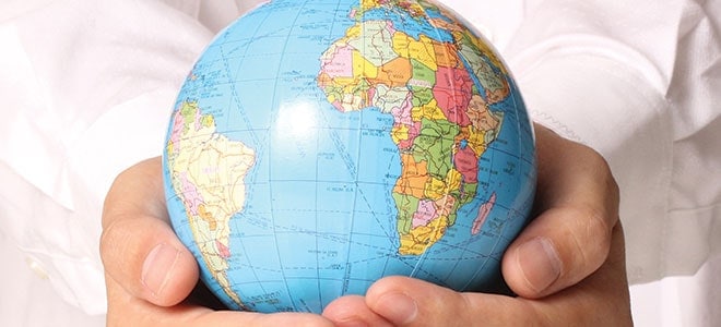 A hand holding a globe illustrating the importance of website translation service