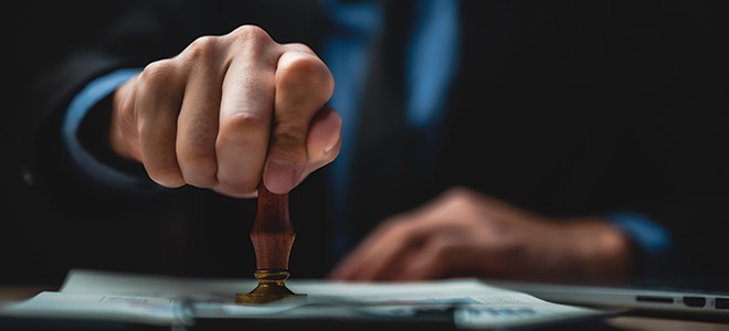 A lawyer stamping on a certified document on when you need a certified translation service company