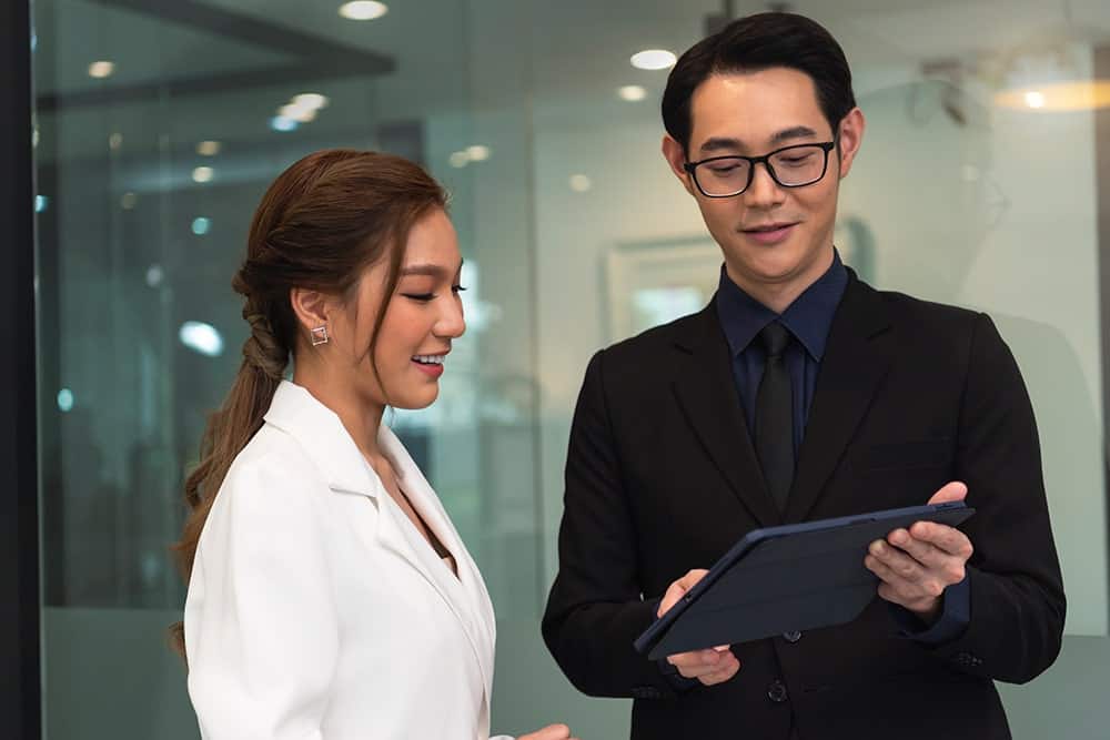 image showing a male worker answering FAQ inquiry from a lady worker