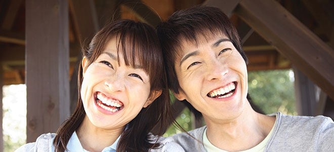 A married couple laughing together illustrating importance of marriage certificate translation services