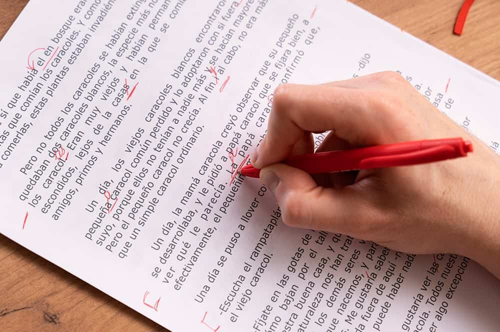 A copy editor at work and editing on a document illustrating the importance of copy editing services