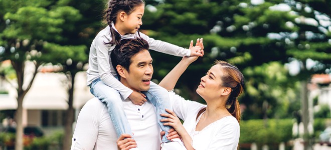 A family of three happily together in outing illustrating guide to Malaysian birth cert translation in Singapore