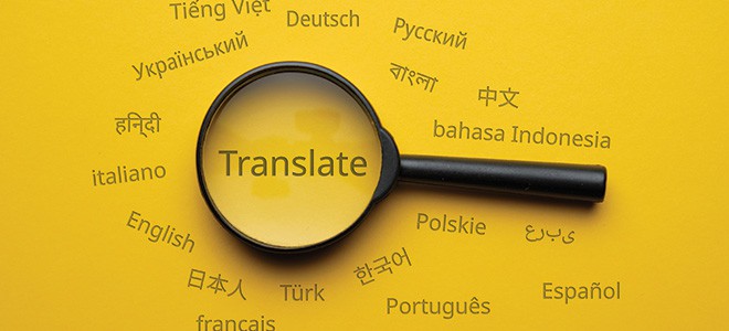 a magnifying glass fixing on the word Translate in yellow background illustrating how translation agency work in singapore