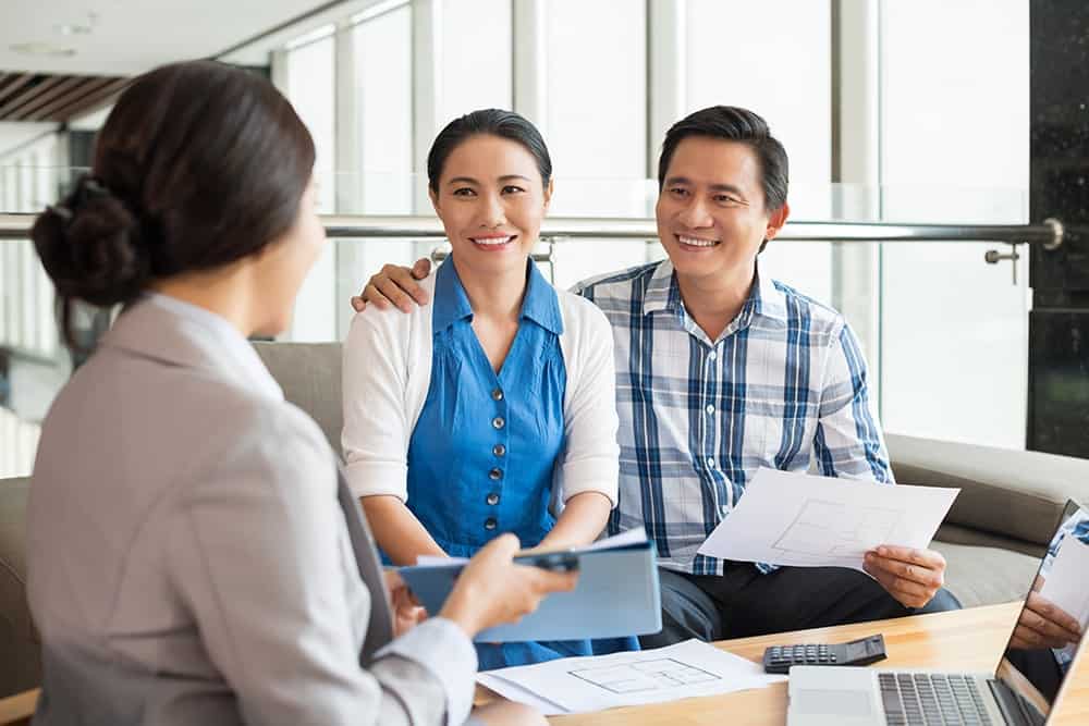 An elderly couple discussing on a translated insurance policy illustrating the importance of insurance translation services