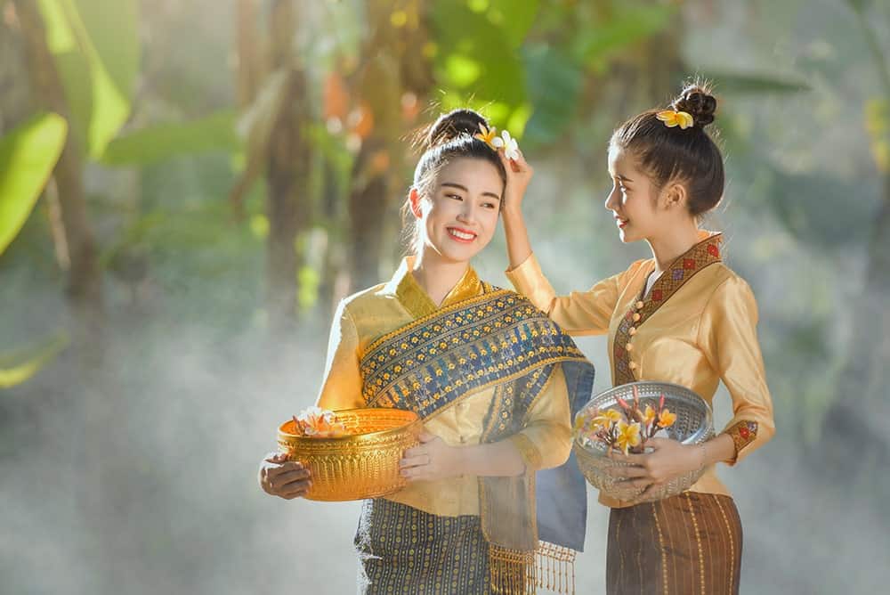 2 Laotian ladies in traditional costumes illustrating the importance of Lao translation services