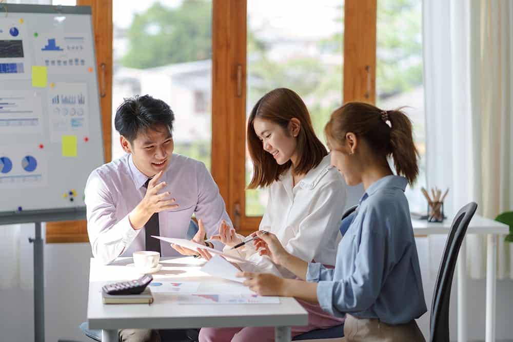 A group of staff discussing market strategies illustrating the importances of marketing translation