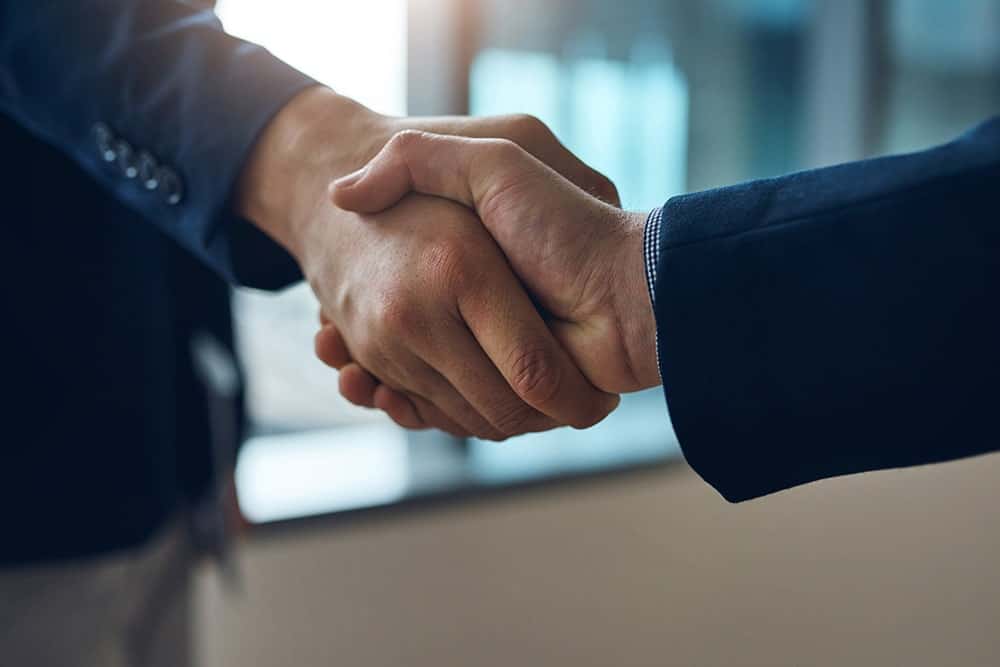 image of business hand shake illustrating the importance of our works done by WhizWordz professional translation services