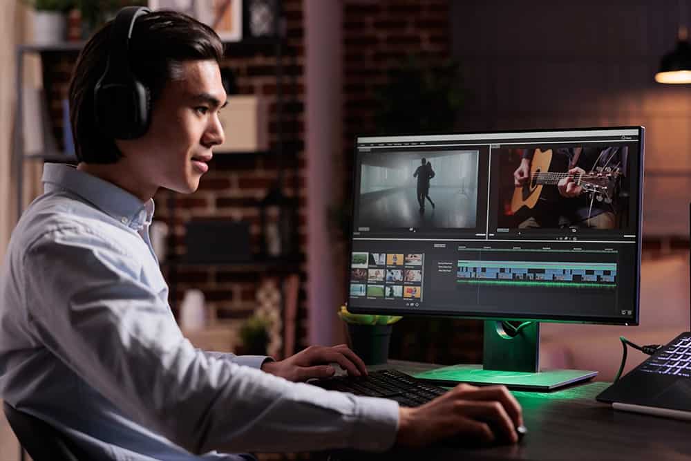 A man wearing a headset and working on a subtitling project illustrating the importance of subtitling services