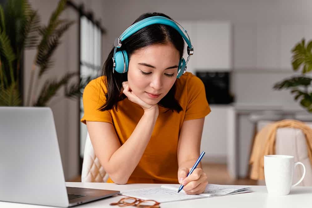 A transcriber at work and listening to the audio recording illustrating the importance of transcription services