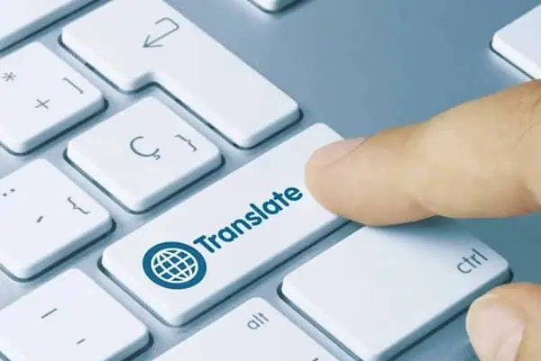 A finger touching the translate button illustrating the importance of translation service